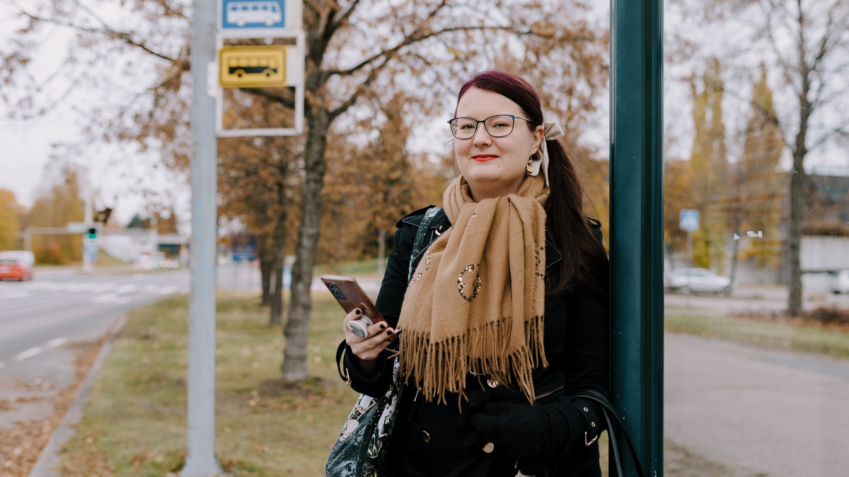 A woman at a bus stop
