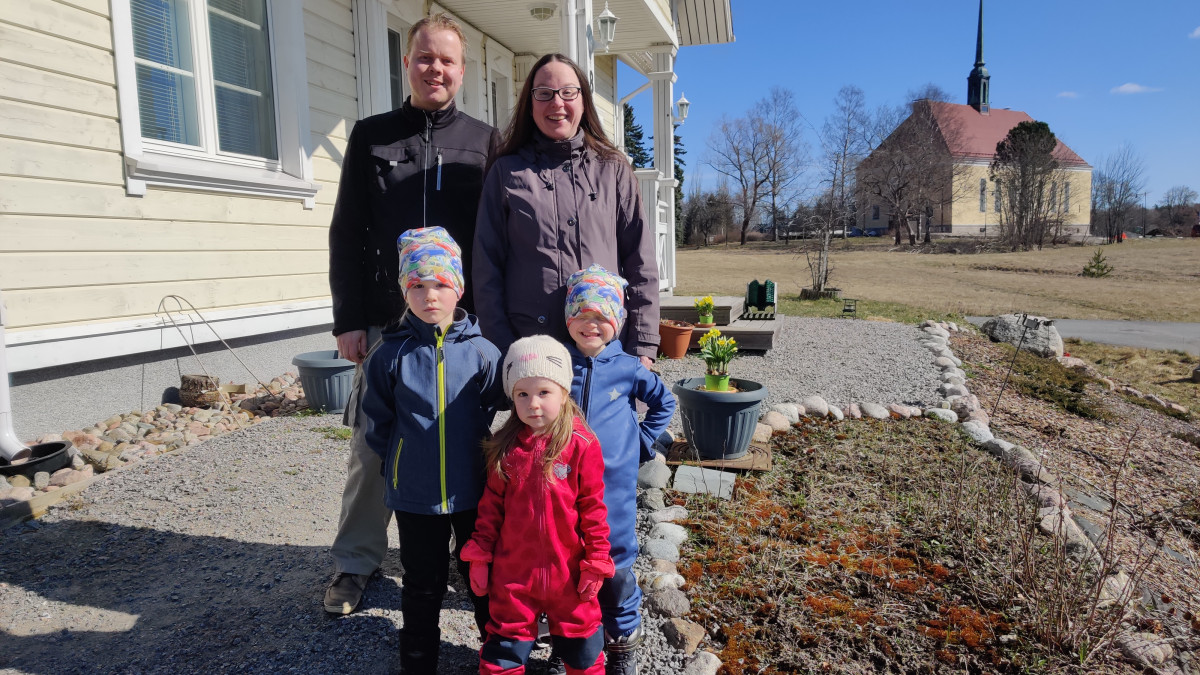 Vesterisen viisihenkinen perhe kuvattuna kotitlaonsa ja Tainionkosken kirkon edustalla.