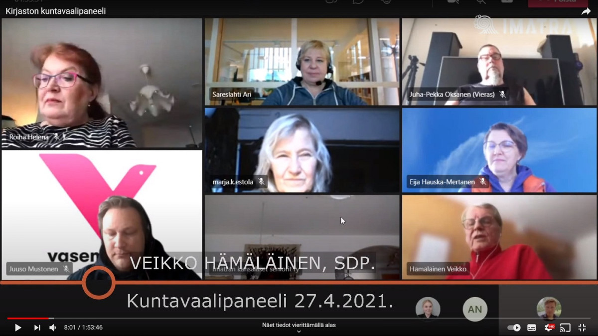 Скриншот из трансляции на YouTube, на котором показаны семь участников дискуссии и ведущий.