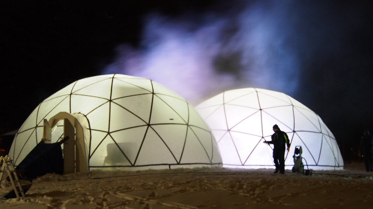 Two ice igloos being built.
