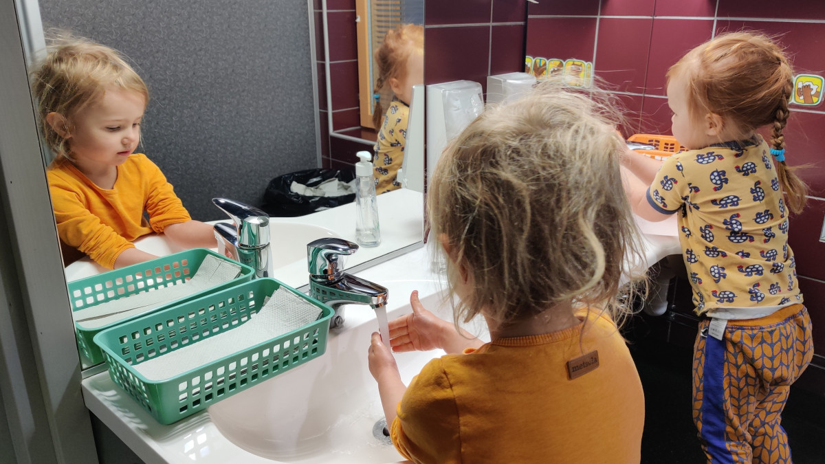Kindergarten children washing their hands.