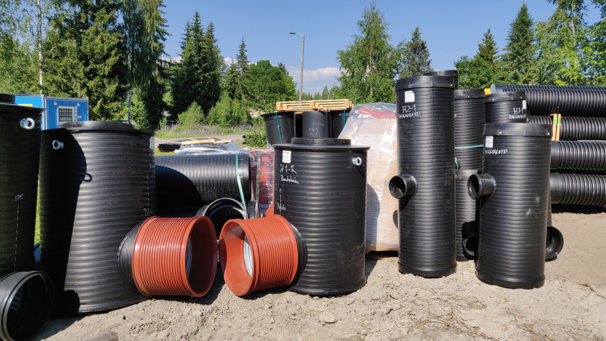 Black water pipes waiting to be installed in the ground in Vintteri.