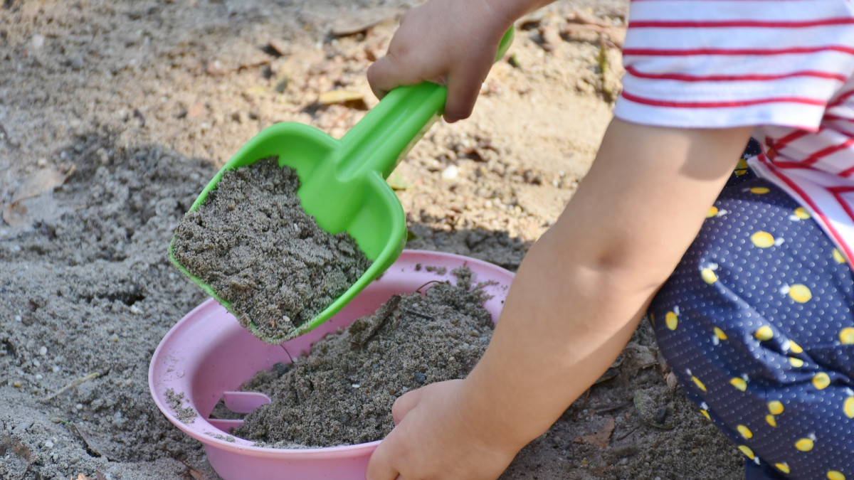 A child in a sandbox.