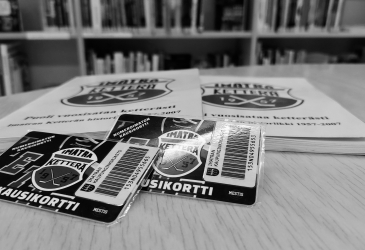 Two Ketterä season tickets and a book about the club's history on the table.