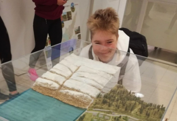 The student looks at the ice age landscape in the display case.