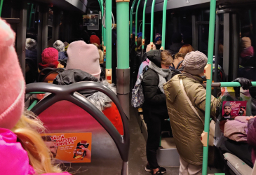People in the bus in winter clothes.