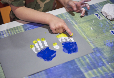 A child's hands make crafts.