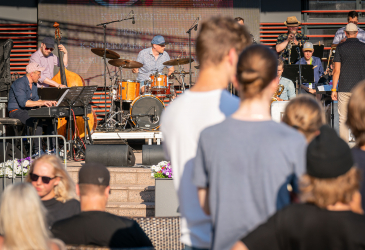 Musicians and people on the pedestrian street of Imatra.