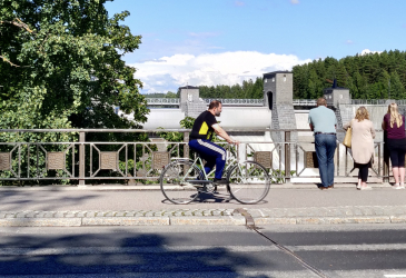 Imatrankoski, people on the bridge watching the rapids and one cyclist.