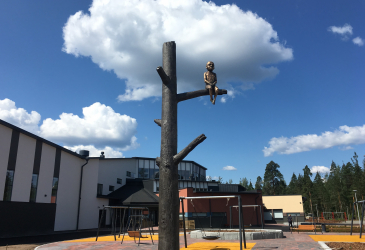 In the middle of the school yard, an aluminum kelohonka was erected, with a bronze boy sitting on the branch.