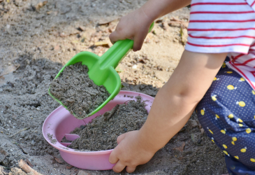 A child in a sandbox.