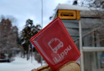 The iLipu case has a bus stop in the background in a winter landscape.