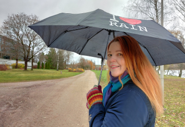 Kati Bragge walks with an umbrella.