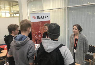 Three young people hearing from two employees of Imatra about summer jobs.