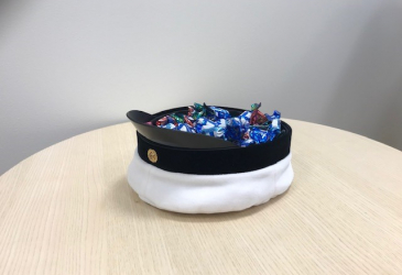 A student cap with candy inside.