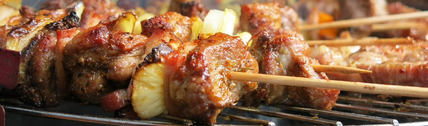 Meat and vegetable skewers on the grill.