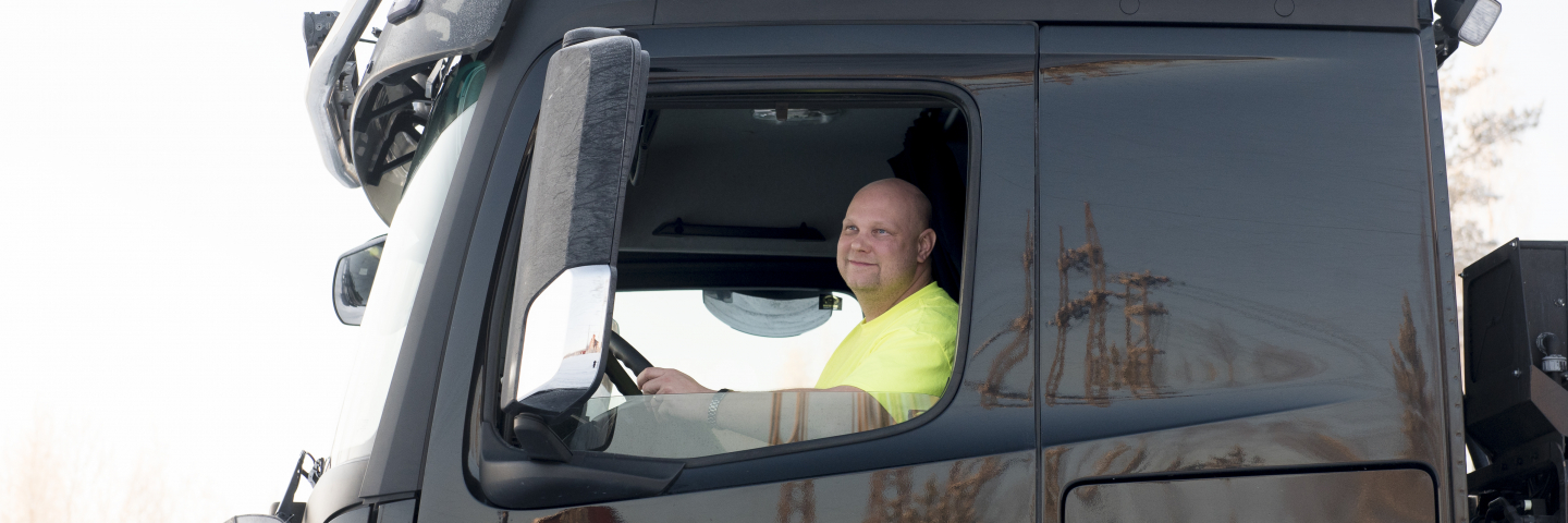 A man behind the wheel of a truck.